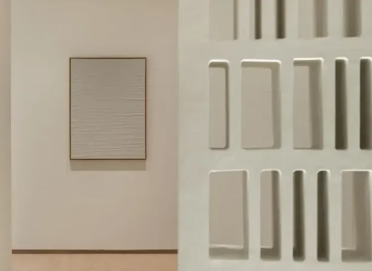Minimalist abstract artwork on white wall at Banyan Tree Dubai with geometric sculptural screen in foreground.webp